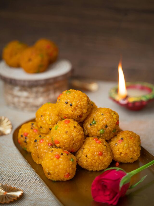 Traditional Diwali setup with boondi laddus and diyas glowing